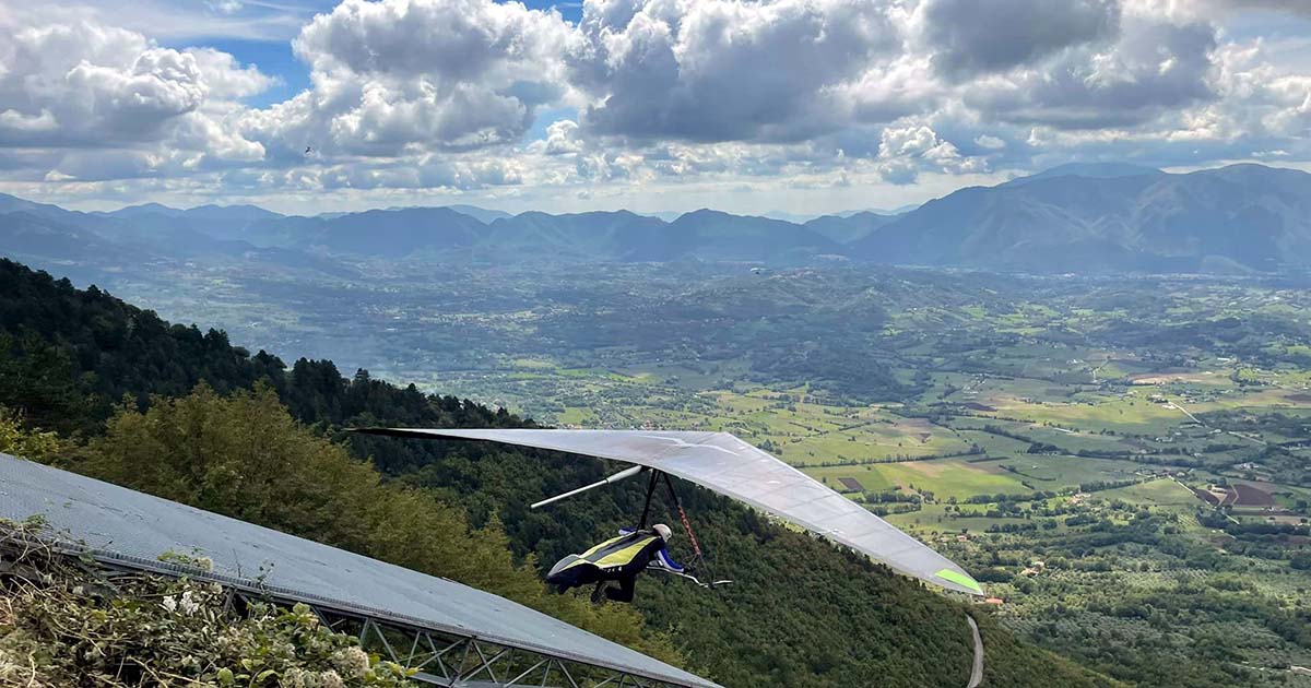 Hang glider ready for takeoff with the valley in the background